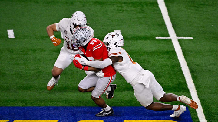 Jan 10, 2025; Arlington, TX, USA; Ohio State Buckeyes wide receiver Carnell Tate (17) and Texas Longhorns linebacker Anthony Hill Jr. (0) and linebacker Liona Lefau (18) in action during the game between the Texas Longhorns and the Ohio State Buckeyes at AT&T Stadium. Mandatory Credit: Jerome Miron-Imagn Images