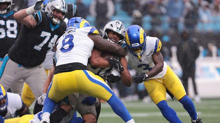 Nov 30, 2025; Charlotte, North Carolina, USA; Carolina Panthers running back Chuba Hubbard (30) rushes as Los Angeles Rams linebacker Jared Verse (8) defends during the third quarter at Bank of America Stadium. Mandatory Credit: Scott Kinser-Imagn Images Nov 30, 2025; Charlotte, North Carolina, USA; Carolina Panthers running back Chuba Hubbard (30) rushes as Los Angeles Rams linebacker Jared Verse (8) defends during the third quarter at Bank of America Stadium. Mandatory Credit: Scott Kinser-Imagn Images