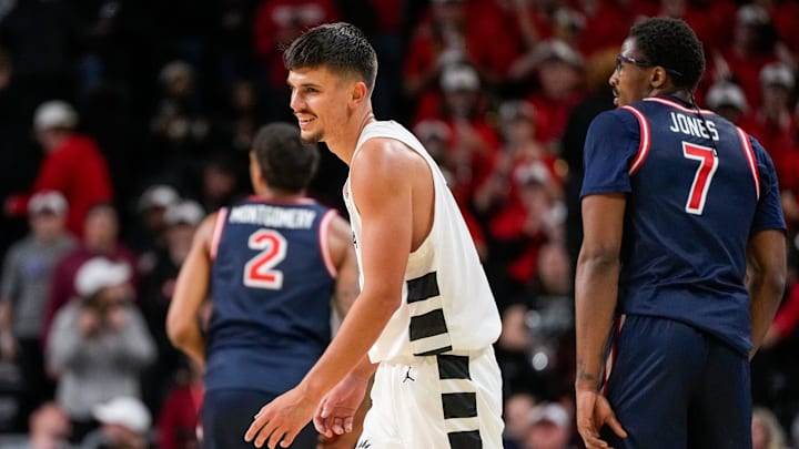 Cincinnati Bearcats guard Kerr Kriisa (11) smiles as time expires in the second half of the NCAA Men’s Basketball game between the Cincinnati Bearcats and the Dayton Flyers at Fifth Third Arena in Cincinnati on Tuesday, Nov. 11, 2025. The Bearcats won 74-62.