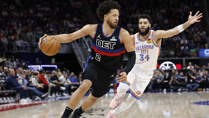 Mar 15, 2025; Detroit, Michigan, USA;  Detroit Pistons guard Cade Cunningham (2) dribbles on Oklahoma City Thunder forward Kenrich Williams (34) in the first half at Little Caesars Arena. Mandatory Credit: Rick Osentoski-Imagn Images
