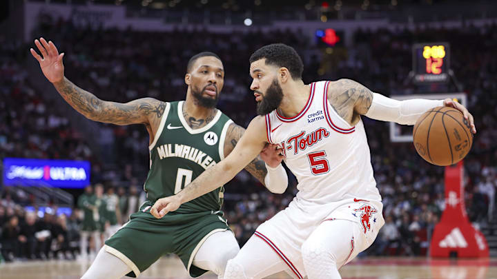 Jan 6, 2024; Houston, Texas, USA; Houston Rockets guard Fred VanVleet (5) controls the ball as Milwaukee Bucks guard Damian Lillard (0) defends during the fourth quarter at Toyota Center. Mandatory Credit: Troy Taormina-Imagn Images