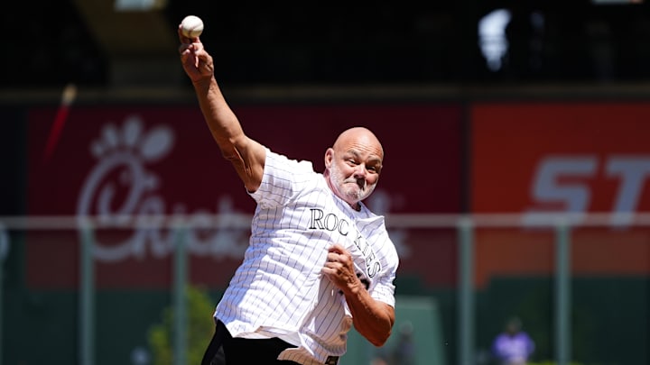 Apr 26, 2025; Denver, Colorado, USA; American former professional baseball player Dante Bichette throws out the first pitch before the game between the Cincinnati Reds against the Colorado Rockies at Coors Field. Mandatory Credit: Ron Chenoy-Imagn Images