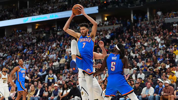 Oct 24, 2024; Denver, Colorado, USA; Oklahoma City Thunder forward Chet Holmgren (7) pulls in a rebound in the second half against the Denver Nuggets at Ball Arena. Mandatory Credit: Ron Chenoy-Imagn Images