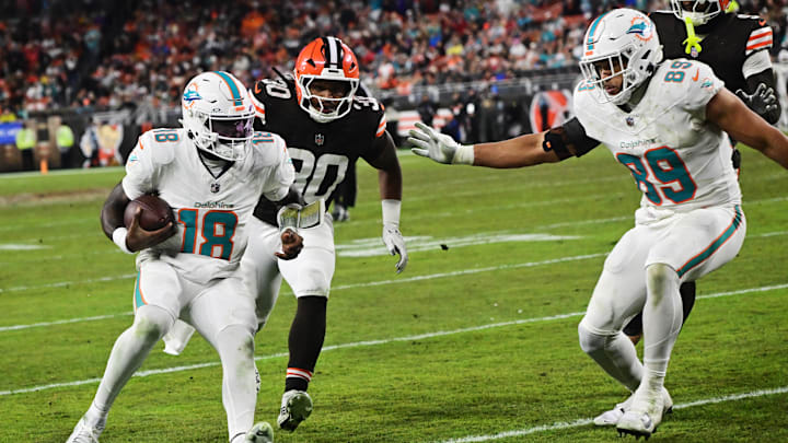 Miami Dolphins quarterback Tyler Huntley (18) scores a touchdown as Cleveland Browns linebacker Devin Bush (30) pursues during the second half at Huntington Bank Field. Miami Dolphins quarterback Tyler Huntley (18) scores a touchdown as Cleveland Browns linebacker Devin Bush (30) pursues during the second half at Huntington Bank Field.