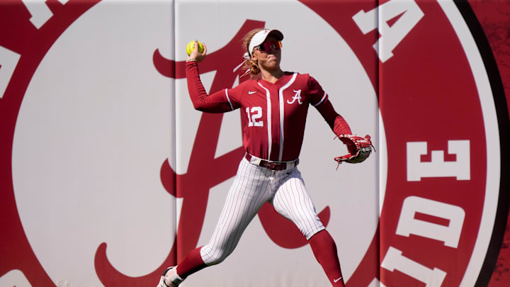Mar 16, 2025; Tuscaloosa AL, USA; Alabama left fielder Audrey Vandagriff (12) throws to the infield after catching a fly ball near the fence in left. Mississippi State defeated Alabama 4-3 Sunday to claim the series two games to one.