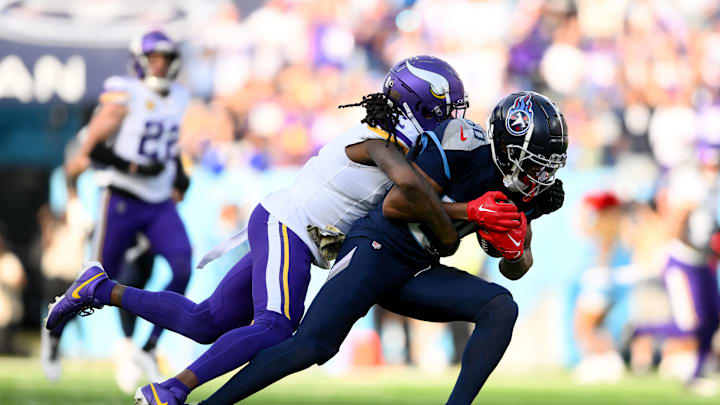 Minnesota Vikings cornerback Stephon Gilmore tackles Tennessee Titans wide receiver Bryce Oliver.