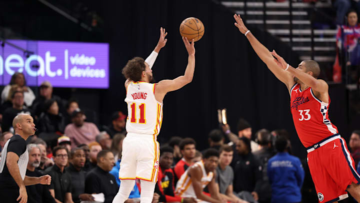 Jan 4, 2025; Inglewood, California, USA;  Atlanta Hawks guard Trae Young (11) shoots the ball against Los Angeles Clippers forward Nicolas Batum (33) during the second quarter at Intuit Dome. Mandatory Credit: Kiyoshi Mio-Imagn Images