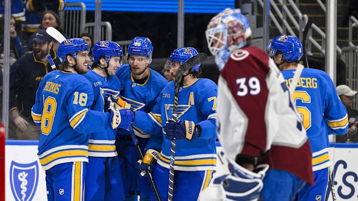 Apr 5, 2025; St. Louis, Missouri, USA;  St. Louis Blues left wing Pavel Buchnevich (89) celebrates with right wing Jimmy Snuggerud (21) center Robert Thomas (18) and defenseman Justin Faulk (72) after scoring against the Colorado Avalanche during the second period at Enterprise Center. Mandatory Credit: Jeff Curry-Imagn Images