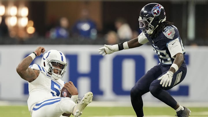 Indianapolis Colts quarterback Anthony Richardson (5) slides as Tennessee Titans cornerback Jarvis Brownlee Jr. (29) rushes