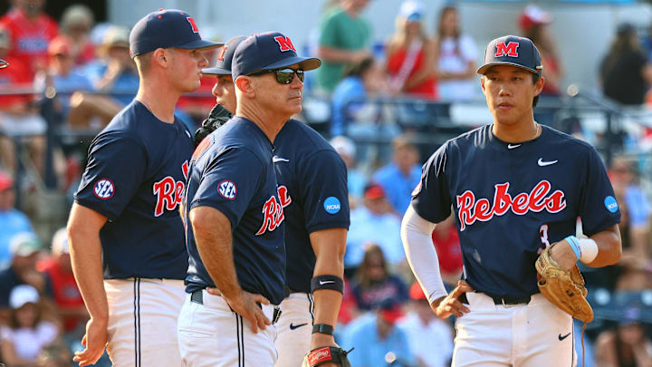 Jun 1, 2025; Oxford, MS, USA; Mississippi Rebels head coach Mike Bianco (left) makes a pitching change during the ninth inning against the Georgia Tech Yellowjackets. Mandatory Credit: Petre Thomas-Imagn Images