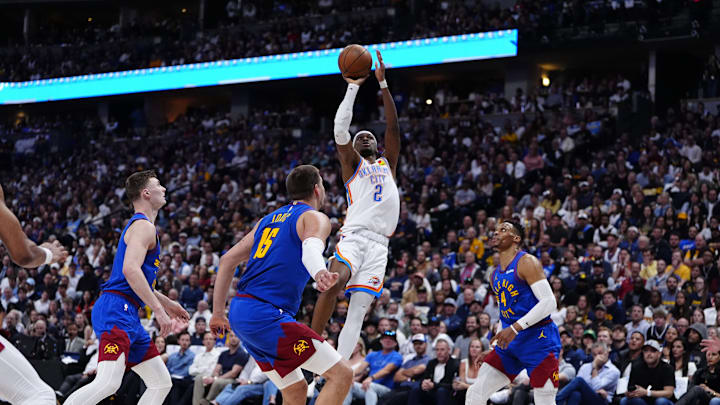 May 9, 2025; Denver, Colorado, USA; Denver Nuggets guard Christian Braun (0),center Nikola Jokic (15) and guard Russell Westbrook (4) watch as Oklahoma City Thunder guard Shai Gilgeous-Alexander (2) prepares to shoot the ball in the second quarter during game three of the second round for the 2025 NBA Playoffs at Ball Arena. Mandatory Credit: Ron Chenoy-Imagn Images