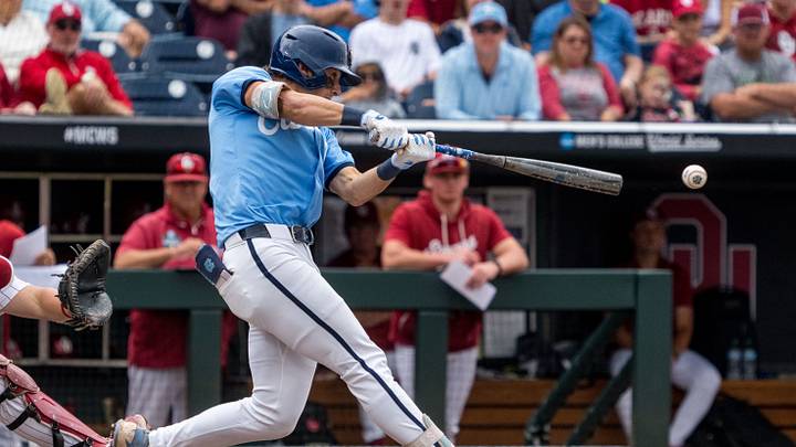 Jun 21, 2026; Omaha, NE, USA; North Carolina Tar Heels shortstop Jake Schaffner (2) hits a two-run triple against the Oklahoma Sooners during the third inning at Charles Schwab Field. Mandatory Credit: Dylan Widger-Imagn Images