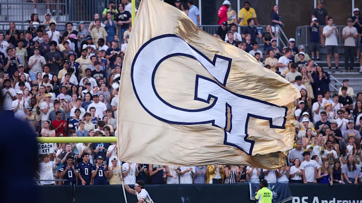 Sep 20, 2025; Atlanta, Georgia, USA; Georgia Tech Yellow Jackets cheerleader runs a flag against the Temple Owls in the third quarter at Bobby Dodd Stadium at Hyundai Field. Mandatory Credit: Brett Davis-Imagn Images