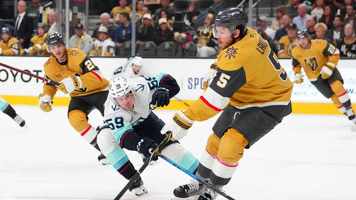 Apr 15, 2026; Las Vegas, Nevada, USA; Vegas Golden Knights defenseman Jeremy Lauzon (5) makes a pass underneath the stick of Seattle Kraken center Ben Meyers (59) during the first period at T-Mobile Arena. Mandatory Credit: Stephen R. Sylvanie-Imagn Images Apr 15, 2026; Las Vegas, Nevada, USA; Vegas Golden Knights defenseman Jeremy Lauzon (5) makes a pass underneath the stick of Seattle Kraken center Ben Meyers (59) during the first period at T-Mobile Arena. Mandatory Credit: Stephen R. Sylvanie-Imagn Images