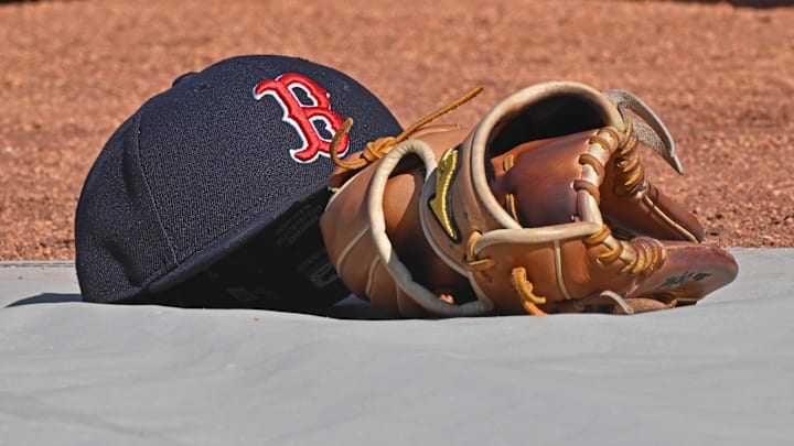 May 10, 2025; Kansas City, Missouri, USA;  A general view of a Boston Red Sox's cap and glove on the field before a game against the Kansas City Royals at Kauffman Stadium. Mandatory Credit: Peter Aiken-Imagn Images
