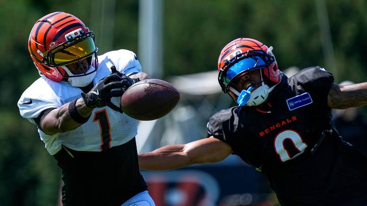 Cincinnati Bengals wide receiver Ja'marr Chase (1) bobbles pass under pressure from cornerback DJ Turner (0) during practice at the Paycor Stadium practice facility in downtown Cincinnati on Tuesday, Aug. 4, 2026. Cincinnati Bengals wide receiver Ja'marr Chase (1) bobbles pass under pressure from cornerback DJ Turner (0) during practice at the Paycor Stadium practice facility in downtown Cincinnati on Tuesday, Aug. 4, 2026.