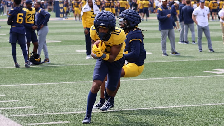 West Virginia University receiver Jarel Williams runs up the sidelines during a passing drill in the 2024 Gold-Blue Spring Game.