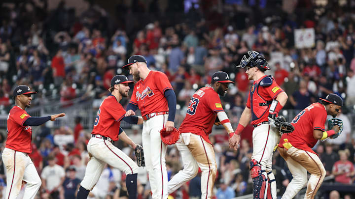 Jun 13, 2025; Cumberland, Georgia, USA; Atlanta Braves second base Ozzie Albies (1), outfielder Eli White (36), pitcher Dylan Lee (52), outfielder Michael Harris II (23), catcher Sean Murphy (12), outfielder Ronald Acuna Jr. (13) shake hands after a victory against the Colorado Rockies during the ninth inning at Truist Park. Mandatory Credit: Jordan Godfree-Imagn Images