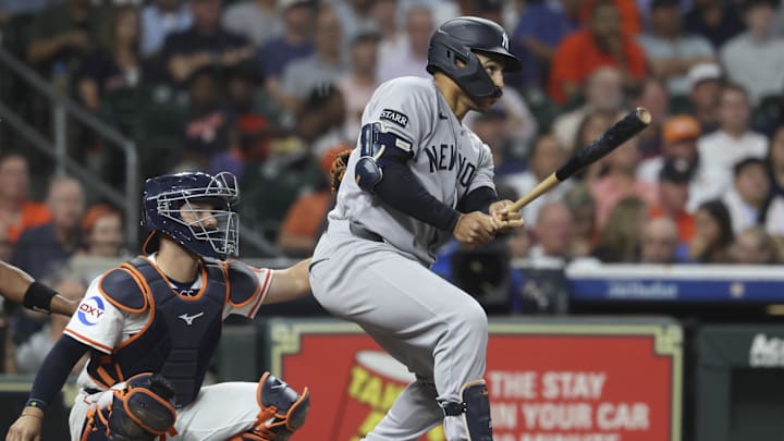 Sep 2, 2025; Houston, Texas, USA; New York Yankees center fielder Trent Grisham (12) hits a single during the second inning against the Houston Astros at Daikin Park. Mandatory Credit: Troy Taormina-Imagn Images