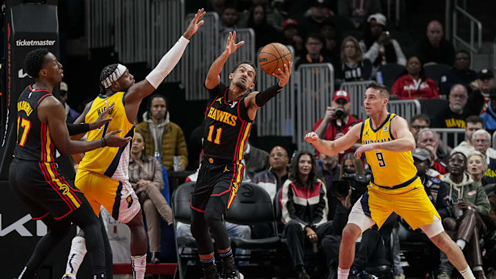 Jan 12, 2024; Atlanta, Georgia, USA; Atlanta Hawks guard Trae Young (11) reaches for a rebound against the Indiana Pacers during the first half at State Farm Arena. Mandatory Credit: Dale Zanine-Imagn Images