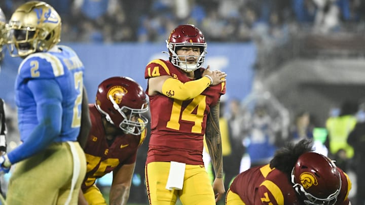 Nov 23, 2024; Pasadena, California, USA; USC Trojans quarterback Jayden Maiava (14) signals a play during the fourth quarter against the UCLA Bruins at Rose Bowl. Mandatory Credit: Robert Hanashiro-Imagn Images
