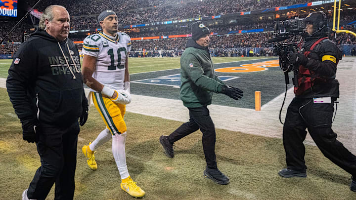 Green Bay Packers quarterback Jordan Love (10) is escorted to the locker room after suffering a concussion during the first quarter of their game against the Chicago Bears Saturday, December 20, 2025 at Soldier Field in Chicago, Illinois.