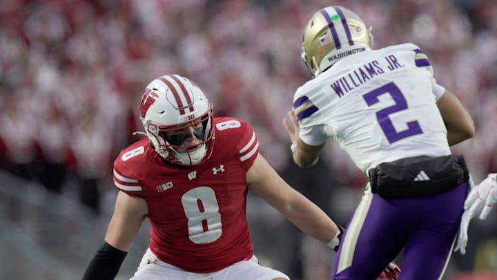 Wisconsin linebacker Mason Posa (8) tackles Washington quarterback Demond Williams Jr. (2) during the first quarter of their game Saturday, November 8, 2025 at Camp Randall Stadium in Madison, Wisconsin.