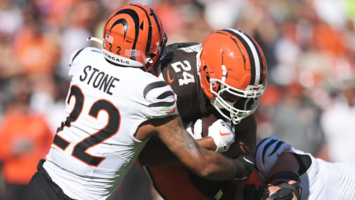 Oct 20, 2024; Cleveland, Ohio, USA; Cincinnati Bengals safety Geno Stone (22) tackles Cleveland Browns running back Nick Chubb (24) during the first half at Huntington Bank Field. Mandatory Credit: Ken Blaze-Imagn Images