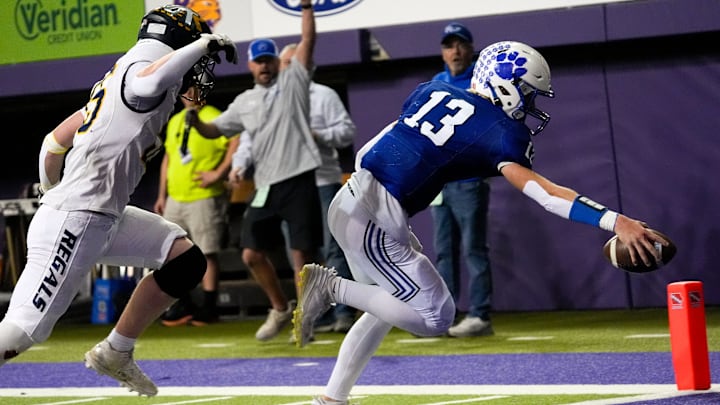 West Lyon’s Easton DeJong (13) runs into the endzone after catching a pass in a trick play Nov. 20, 2025 during the Class 1A state football championship against the Iowa City Regina Regals at the UNI-Dome in Cedar Falls, Iowa.