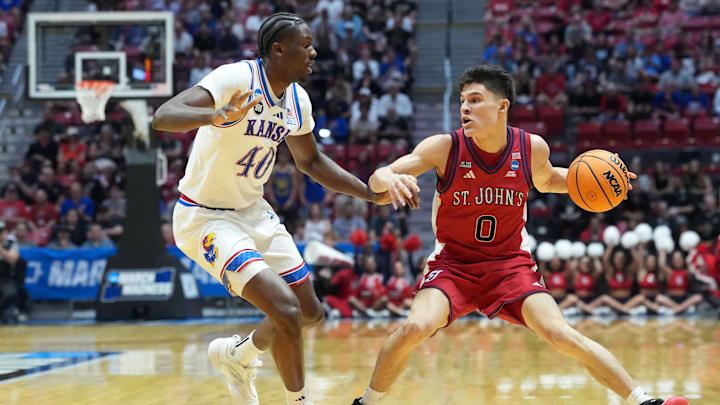 Mar 22, 2026; San Diego, CA, USA; St. John's Red Storm guard Dylan Darling (0) controls the ball against Kansas Jayhawks forward Flory Bidunga (40) in the first half during a second round game of the men's 2026 NCAA Tournament at Viejas Arena. Mandatory Credit: Kirby Lee-Imagn Images