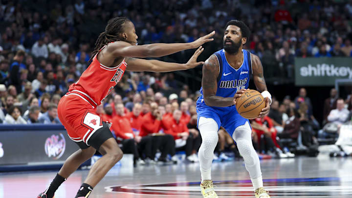 Nov 6, 2024; Dallas, Texas, USA;  Dallas Mavericks guard Kyrie Irving (11) looks to shoot as Chicago Bulls guard Ayo Dosunmu (11) defends during the second half at American Airlines Center. Mandatory Credit: Kevin Jairaj-Imagn Images