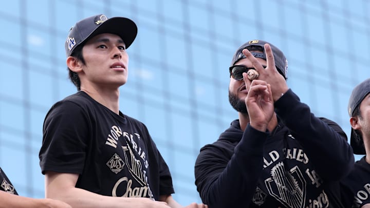Nov 3, 2025; Los Angeles, CA, USA; Los Angeles Dodgers pitcher Roki Sasaki (left) acknowledges the crowd during the World Series championship parade at downtown Los Angeles. Mandatory Credit: Kiyoshi Mio-Imagn Images