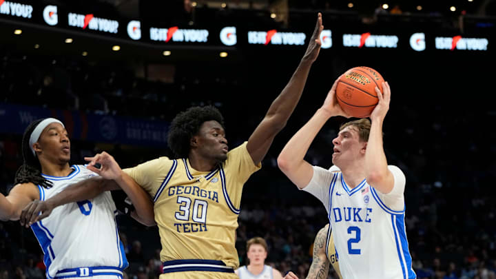 Mar 13, 2025; Charlotte, NC, USA; Duke Blue Devils forward Cooper Flagg (2) with the ball as Georgia Tech Yellow Jackets forward Ibrahim Souare (30) defends in the first half at Spectrum Center. Mandatory Credit: Bob Donnan-Imagn Images