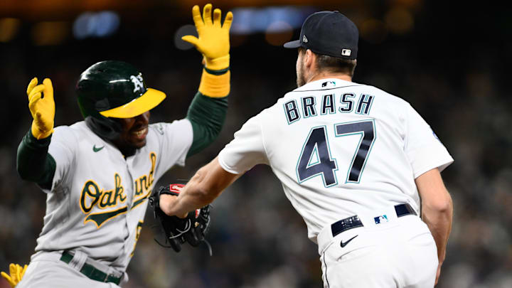 Seattle Mariners relief pitcher Matt Brash (47) tags Oakland Athletics left fielder Tony Kemp (5) at first base during the sixth inning at T-Mobile Park in 2023.