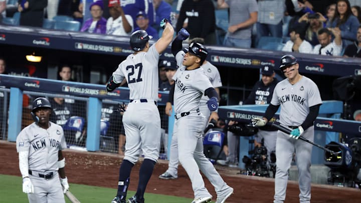Oct 25, 2024; Los Angeles, California, USA; New York Yankees designated hitter Giancarlo Stanton (27) celebrate with outfielder Juan Soto (22) after scoring on a two run home run in the sixth inning against the Los Angeles Dodgers during game one of the 2024 MLB World Series at Dodger Stadium. Mandatory Credit: Kiyoshi Mio-Imagn Images