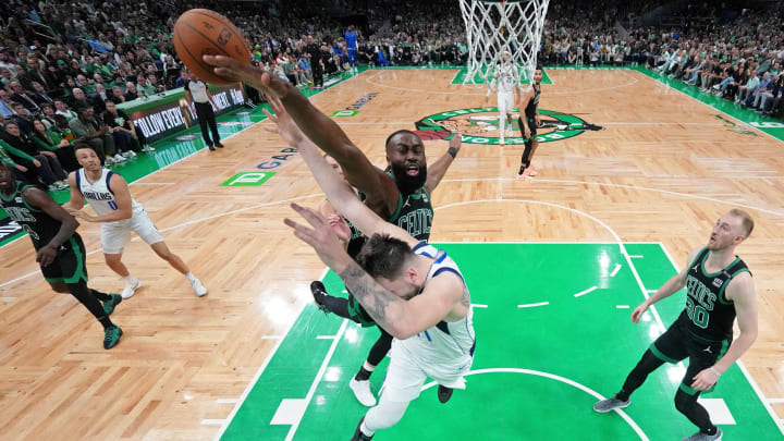 Jun 9, 2024; Boston, Massachusetts, USA; Boston Celtics guard Jaylen Brown (7) blocks the shot of Dallas Mavericks guard Luka Doncic (77) during the third quarter in game two of the 2024 NBA Finals at TD Garden. Mandatory Credit: Peter Casey-USA TODAY Sports