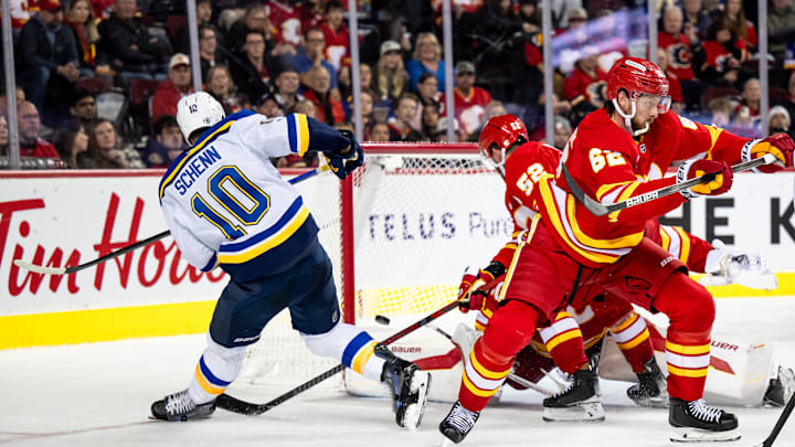 Dec 5, 2024; Calgary, Alberta, CAN; St. Louis Blues center Brayden Schenn (10) is stopped by Calgary Flames goaltender Daniel Vladar (80) during the third period at Scotiabank Saddledome. Mandatory Credit: Brett Holmes-Imagn Images