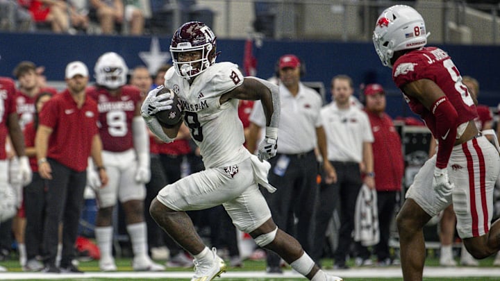 Sep 30, 2023; Arlington, Texas, USA; Texas A&M Aggies running back Le'Veon Moss (8) and Arkansas Razorbacks defensive back Jayden Johnson (8) In action during the game between the Texas A&M Aggies and the Arkansas Razorbacks at AT&T Stadium. Mandatory Credit: Jerome Miron-Imagn Images