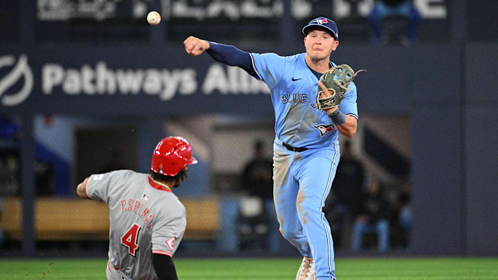 Aug 19, 2024; Toronto, Ontario, CAN; Toronto Blue Jays second baseman Will Wagner (7) throws to first base for a double play after forcing out Cincinnati Reds third baseman Santiago Espinal (4) in the ninth inning at Rogers Centre.