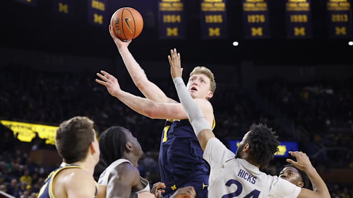 Jan 27, 2025; Ann Arbor, Michigan, USA;  Michigan Wolverines center Danny Wolf (1) shoots over Penn State Nittany Lions forward Zach Hicks (24) in the first half at Crisler Center. Mandatory Credit: Rick Osentoski-Imagn Images