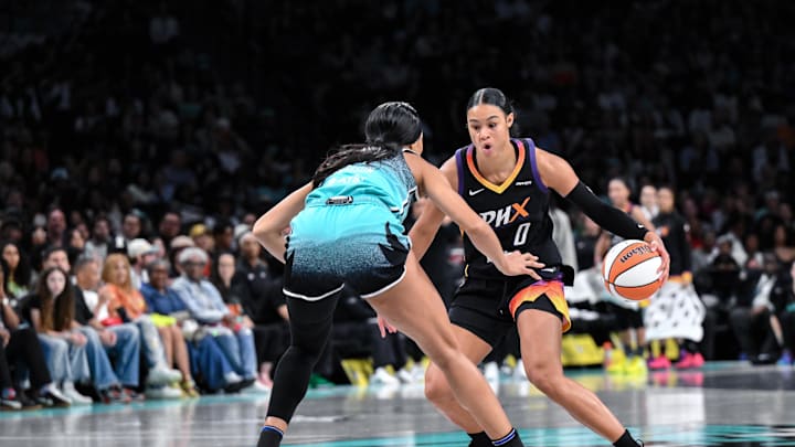 Jun 19, 2025; Brooklyn, New York, USA; Phoenix Mercury forward Satou Sabally (0) makes a move against New York Liberty forward Isabelle Harrison (21) during the second half at Barclays Center. Mandatory Credit: John Jones-Imagn Images