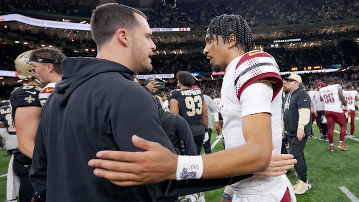 Dec 15, 2024; New Orleans, Louisiana, USA; New Orleans Saints quarterback Derek Carr, left, greets Washington Commanders quarterback Jayden Daniels (5) at the end of the game at Caesars Superdome. Mandatory Credit: Matthew Hinton-Imagn Images