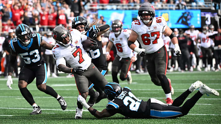 Dec 21, 2025; Charlotte, North Carolina, USA; Tampa Bay Buccaneers running back Bucky Irving (7) runs against Carolina Panthers safety Nick Scott (21) and linebacker Christian Rozeboom (56) during the first half at Bank of America Stadium. Mandatory Credit: Bob Donnan-Imagn Images Dec 21, 2025; Charlotte, North Carolina, USA; Tampa Bay Buccaneers running back Bucky Irving (7) runs against Carolina Panthers safety Nick Scott (21) and linebacker Christian Rozeboom (56) during the first half at Bank of America Stadium. Mandatory Credit: Bob Donnan-Imagn Images