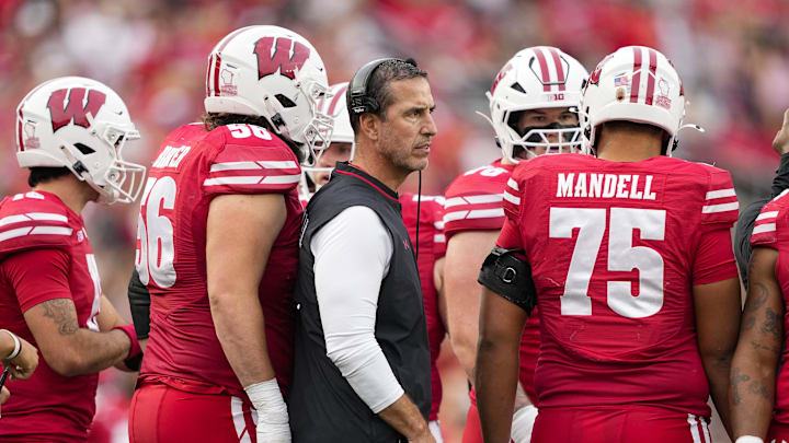 Oct 18, 2025; Madison, Wisconsin, USA; Wisconsin Badgers head coach Luke Fickell stands in the offensive huddle during the game against the Ohio State Buckeyes at Camp Randall Stadium. Oct 18, 2025; Madison, Wisconsin, USA; Wisconsin Badgers head coach Luke Fickell stands in the offensive huddle during the game against the Ohio State Buckeyes at Camp Randall Stadium.