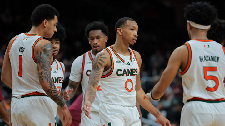 Jan 8, 2025; Coral Gables, Florida, USA; Miami Hurricanes guard Matthew Cleveland (0) high-fives with teammates against the Florida State Seminoles during the second half at Watsco Center. Mandatory Credit: Sam Navarro-Imagn Images