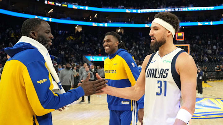 Dec 15, 2024; San Francisco, California, USA; Dallas Mavericks guard Klay Thompson (31) greets Golden State Warriors forward Draymond Green (left) after the game at Chase Center. Mandatory Credit: Darren Yamashita-Imagn Images