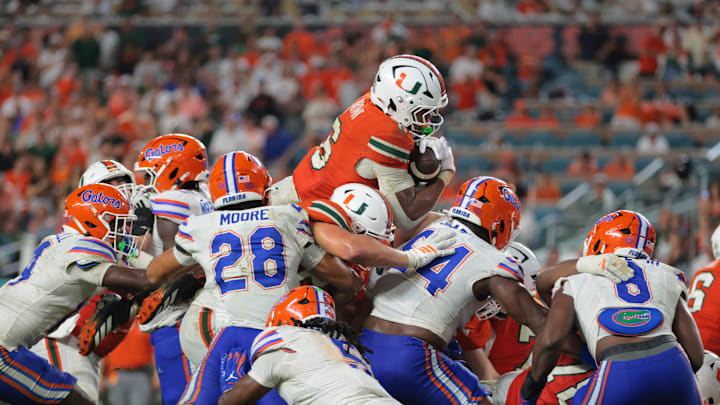 Sep 20, 2025; Miami Gardens, Florida, USA; Miami Hurricanes running back CharMar Brown (6) jumps over the pile for a touchdown against the Florida Gators during the fourth quarter at Hard Rock Stadium. Mandatory Credit: Sam Navarro-Imagn Images
