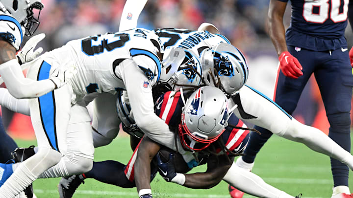 Aug 8, 2024; Foxborough, Massachusetts, USA; New England Patriots running back JaMycal Hasty (39) is tackled by Carolina Panthers linebacker Tae Davis (33) and safety Demani Richardson (36) during the second half at Gillette Stadium. Mandatory Credit: Brian Fluharty-USA TODAY Sports