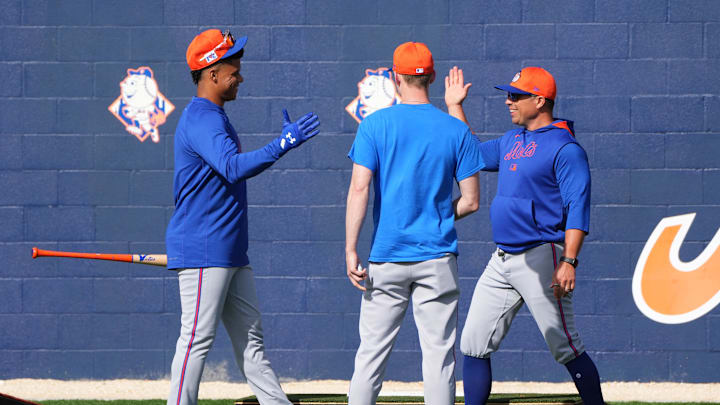Feb 16, 2025; Port St. Lucie, FL, USA; New York Mets outfielder Juan Soto (22) greets assistant pitching coach Desi Druschel, right, and vice president of pitching, Eric Jagers on his first day of spring training with the Mets. Mandatory Credit: Jim Rassol-Imagn Images