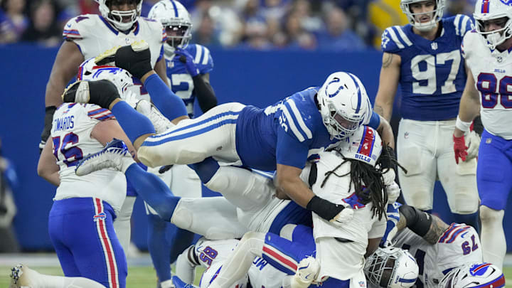 Indianapolis Colts defensive tackle Grover Stewart (90) tackles Buffalo Bills running back James Cook (4) on Sunday, Nov. 10, 2024, during a game against the Buffalo Bills at Lucas Oil Stadium in Indianapolis.